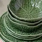 a stack of green and pink plates sitting on top of each other